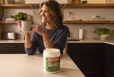 middle aged woman with great hair enjoying a cup of coffee