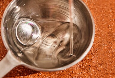 MCT Oil being poured onto a measuring spoon