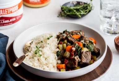 A plate of slow-cooked beef stew with cauliflower rice