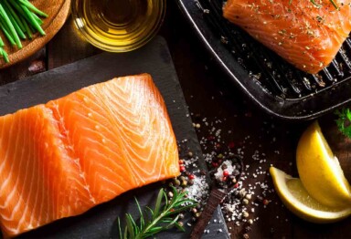 raw salmon on table with cooking ingredients