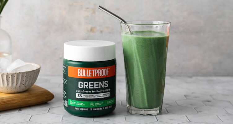 green smoothie next to a jar of bulletproof greens powder