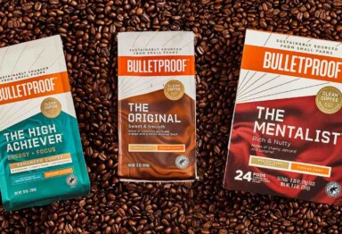 Bulletproof coffee packages, The High Achiever, The Original and the Mentalist, laying on coffee beans.