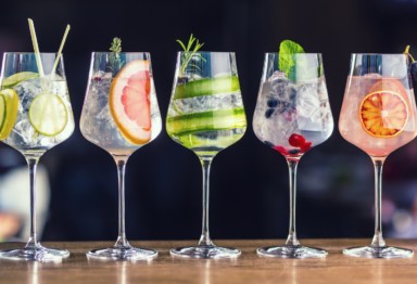 A collection of different cocktails on a bartop