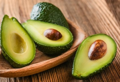 Bowl of avocados cut in half