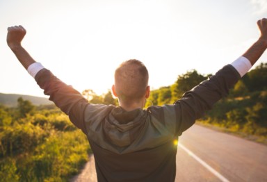 Man raising arms in the air in celebration.