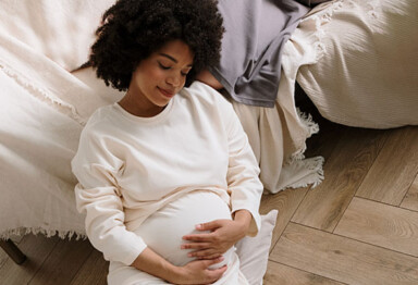 pregnant woman holds her belly