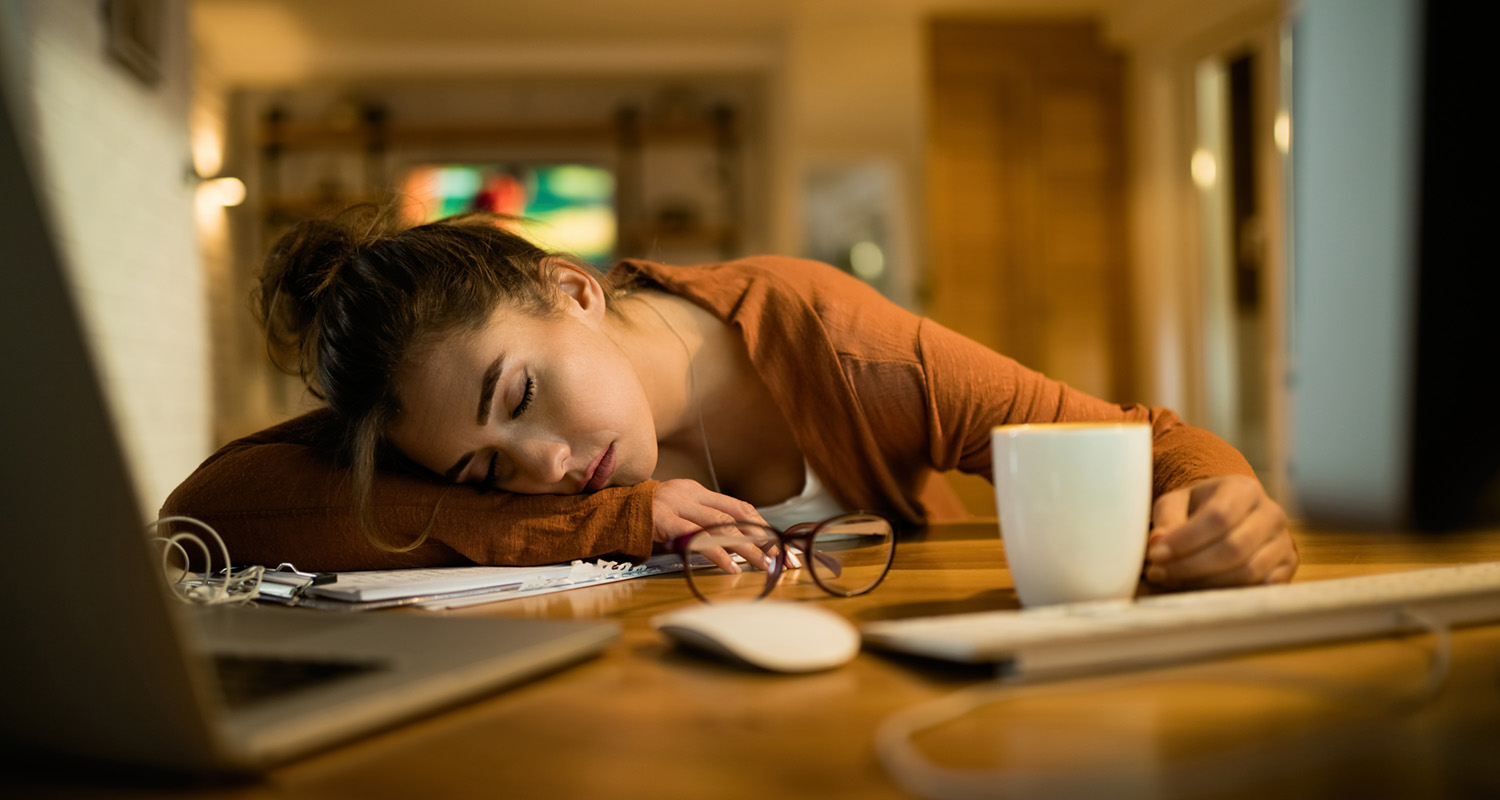 woman napping at her work desk